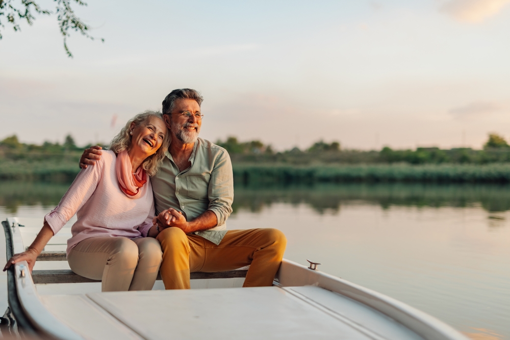 Elderly,Couple,Holding,Hands,And,Laughing,,Enjoying,A,Peaceful,Moment